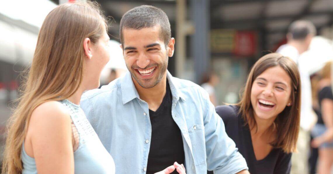 A man smiling at his girlfriend