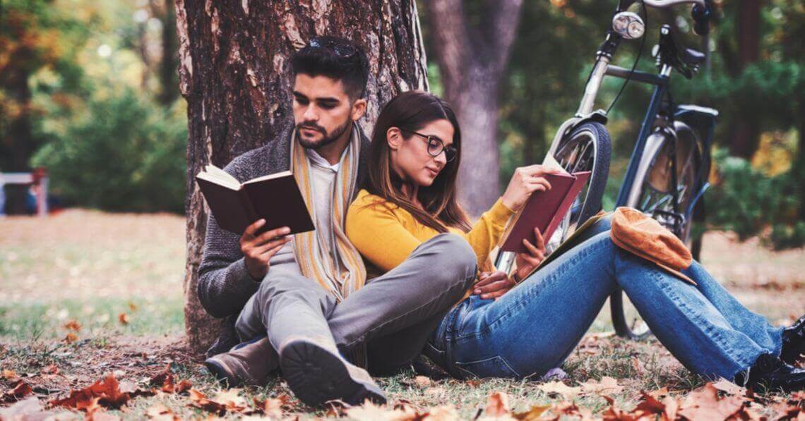 A couple reading their books in the nature