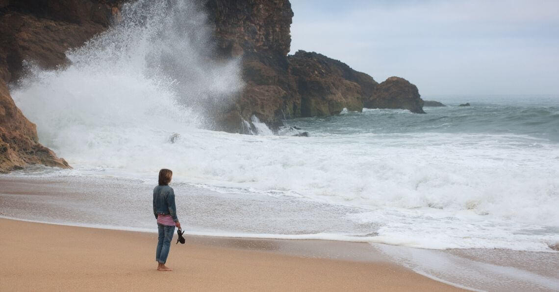 A woman standing by the ocean