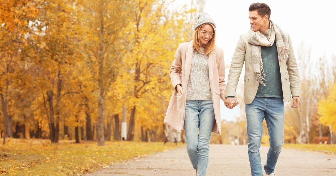 A couple holding hands, taking a walk