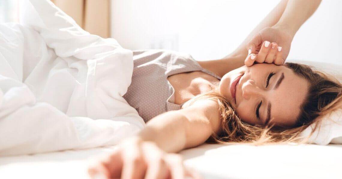 Happy young woman waking up