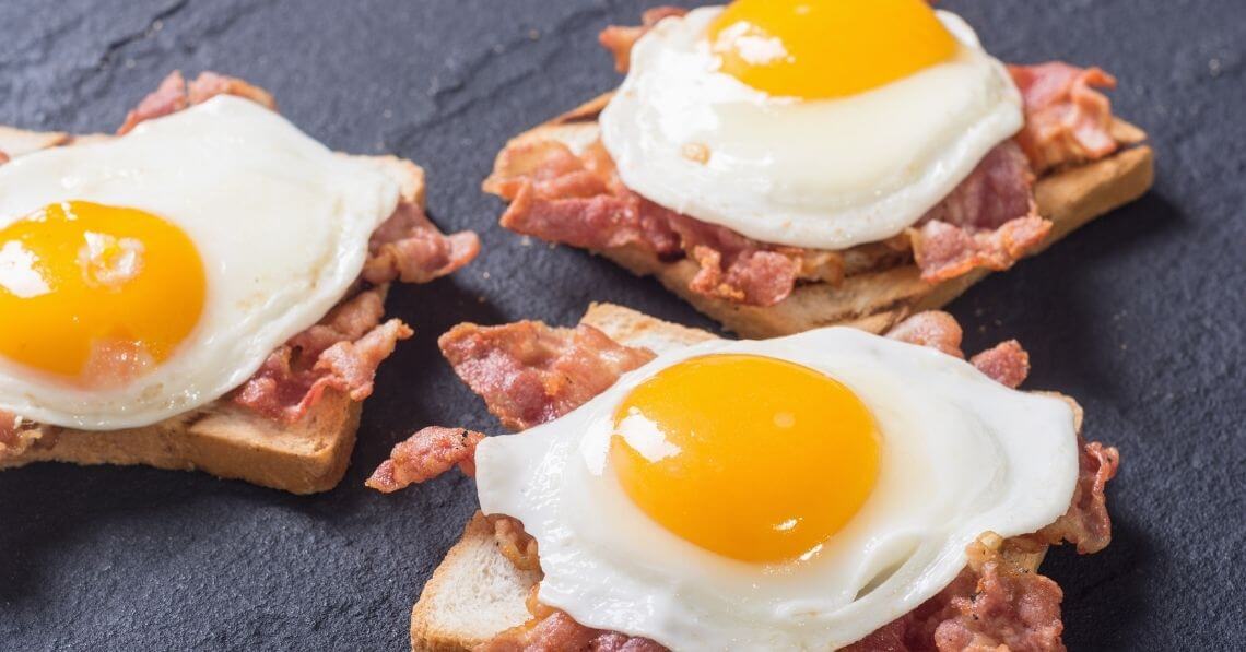 Bacon and eggs over bread