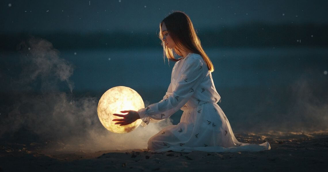 A woman holding a moon 
