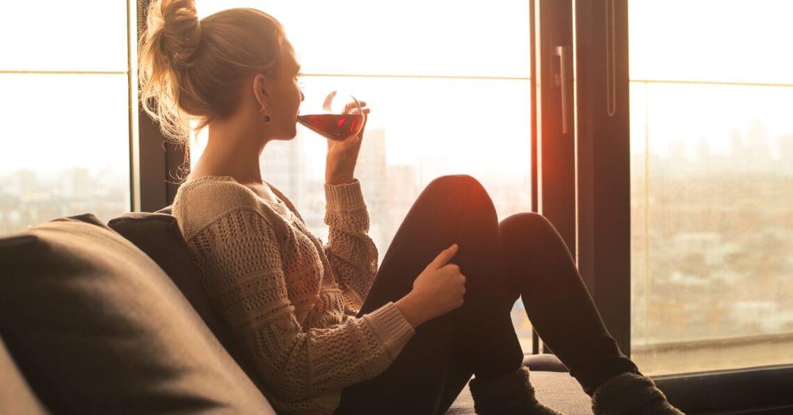 Young woman relaxing with a glass of red wine