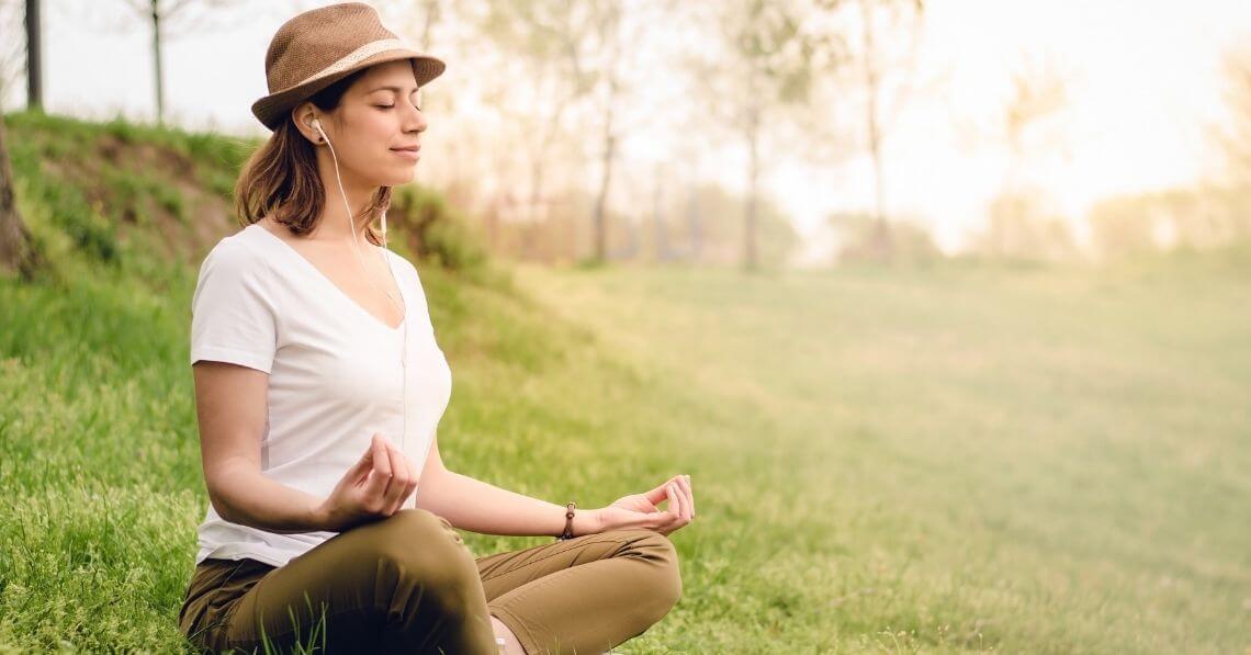 Young woman meditating in the park