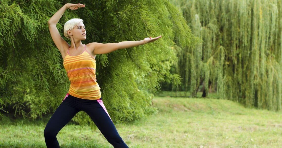 Young woman doing thai chi in the nature