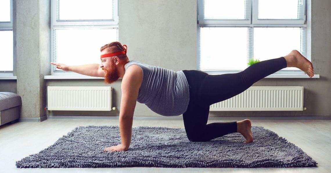 Man doing yoga at home