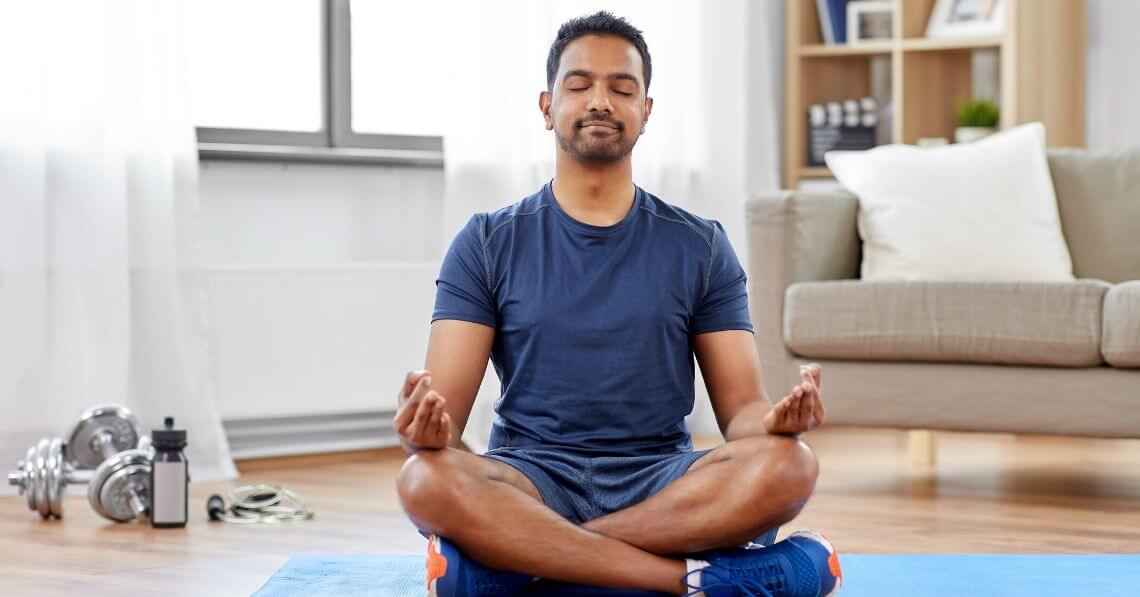 Young man meditating before working out