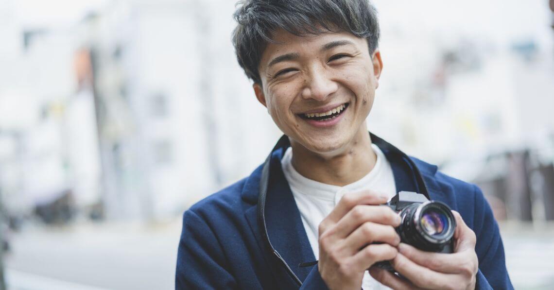 Smiling man enjoying photography hobby