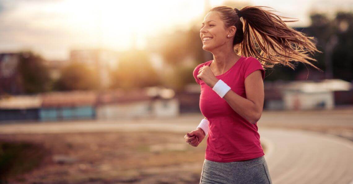 Smiling young woman running