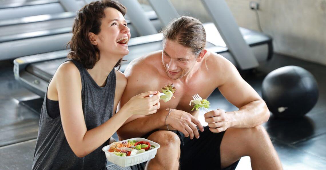 A happy couple having luncg after workout