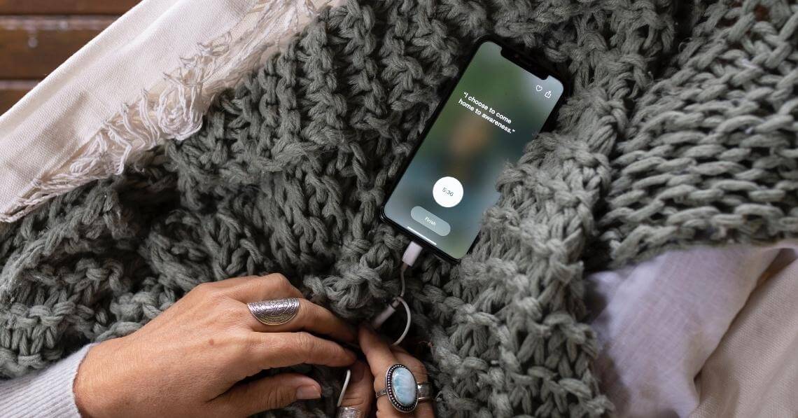 woman using meditation app on her smart phone