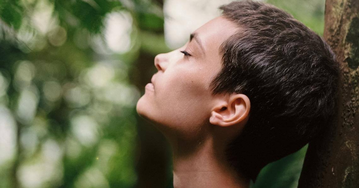 woman doing breathing exercises in the nature