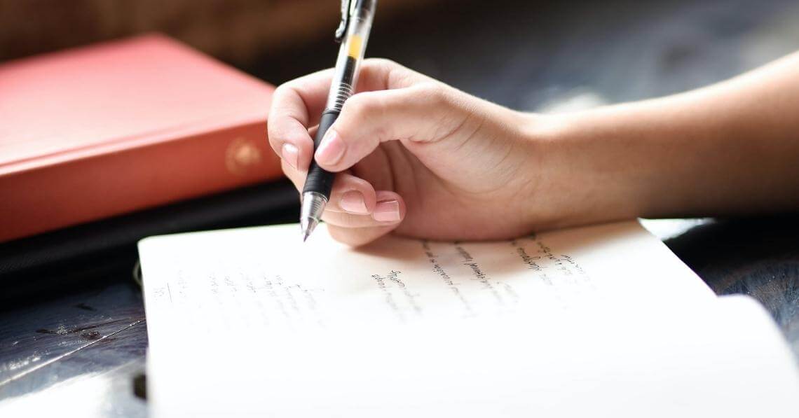 woman writing on her journal