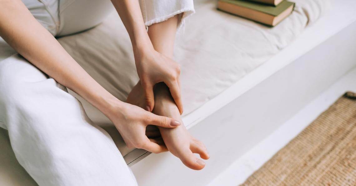 woman giving herself a foot massage