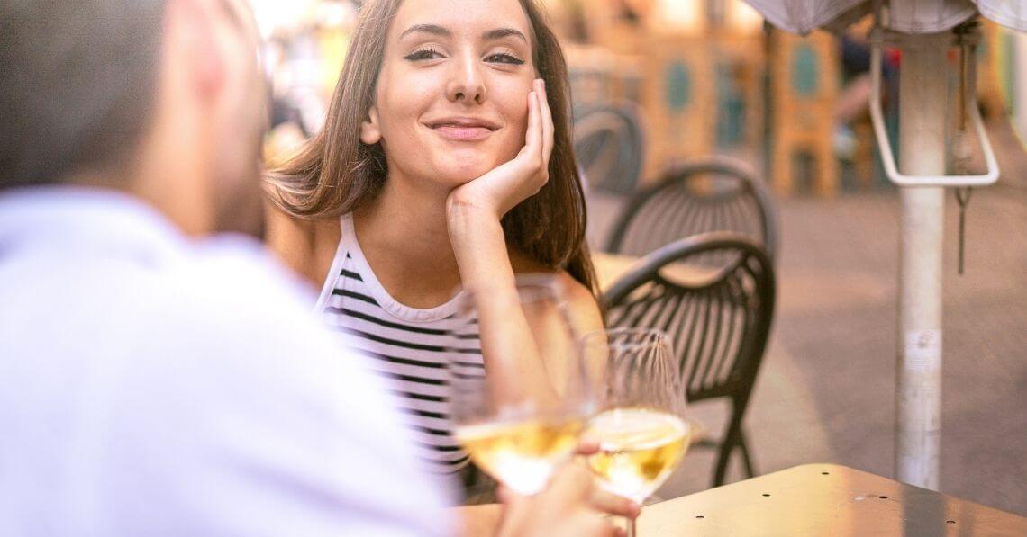 A couple cheering with white wine