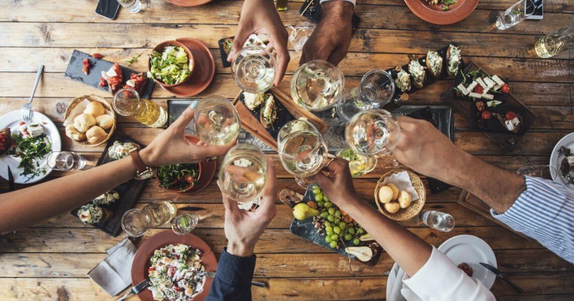 A group of people toasting at the dinner table