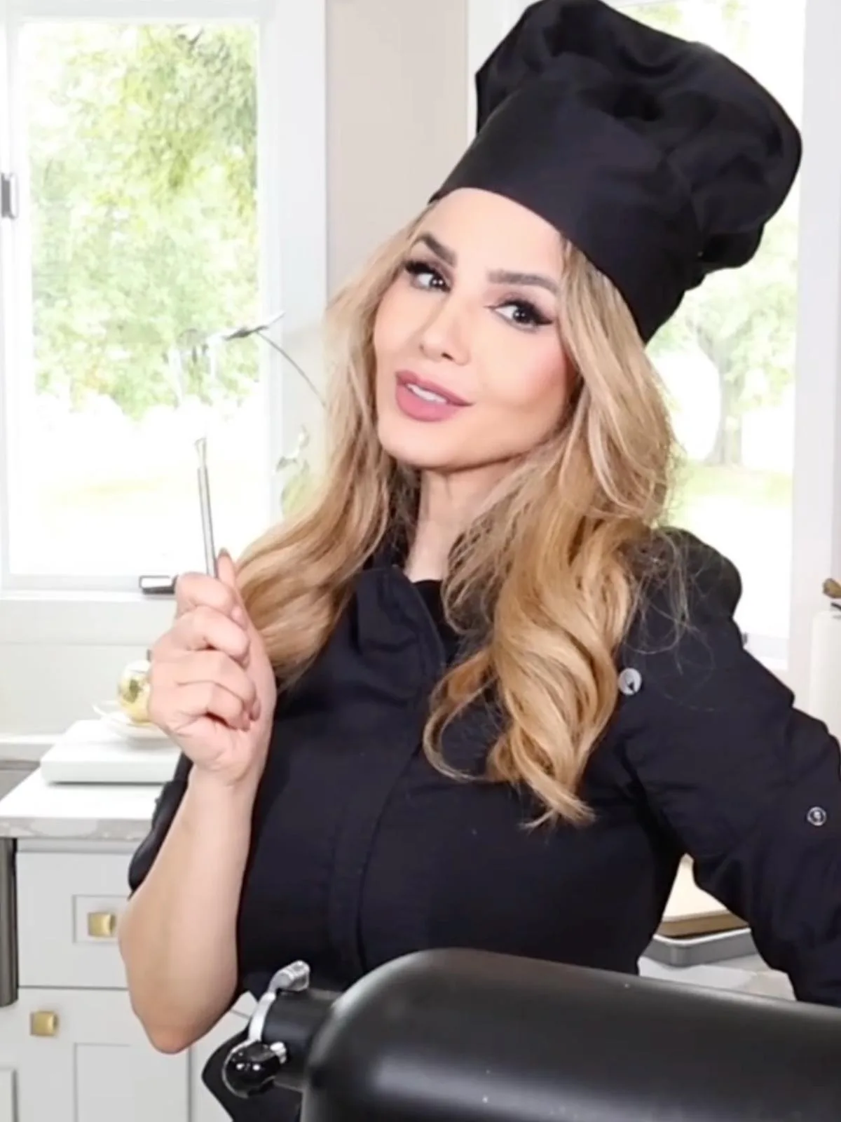 Leili Malakooti in her kitchen, wearing chef's whites