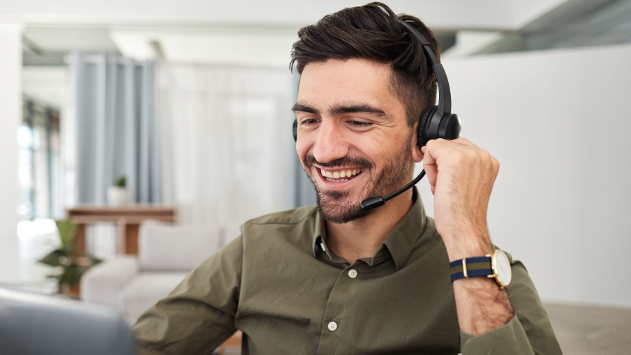 Male receptionist wearing a headset answering a call