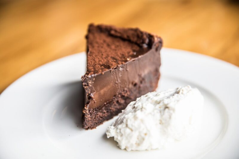 thick slice of Beatrix's Tall Dark and Handsome chocolate cake on white plate