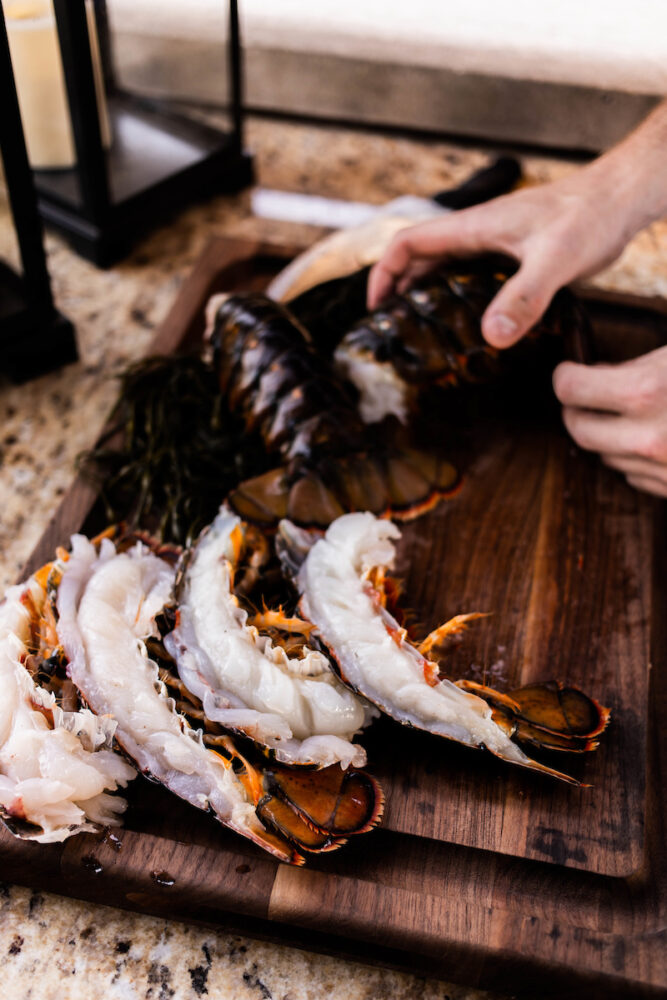 Chef Justin with lobsters cut in half