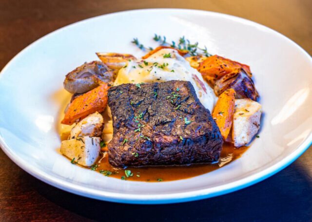 plate of Wildfire Short Ribs with root vegetables