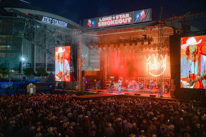 A performer on stage at Lone Star Smokeout in front of a crowd