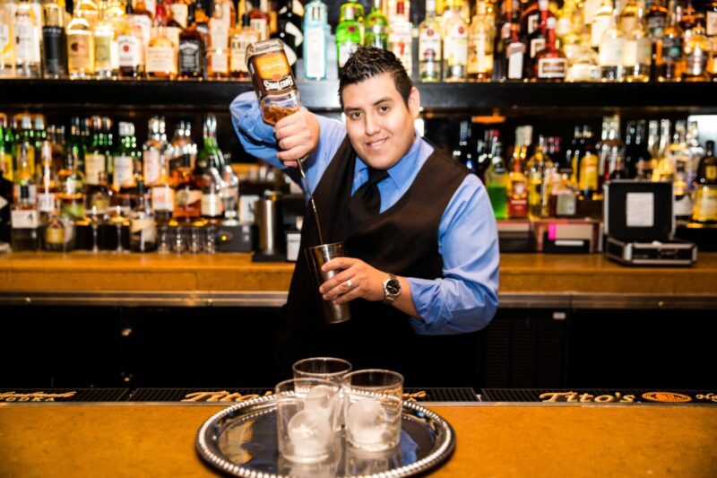 Di Pescara's Bartender and Server Bobby pouring a cocktail at the bar