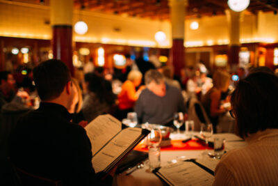 Shaw's Dining Room with diners looking at a menu