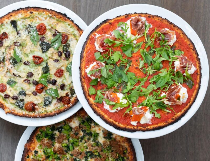 Three overlap cauliflower pizzas with carious toppings from Pizzeria Portofino