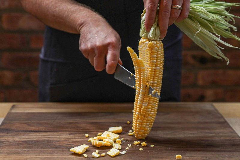 Corn being cut by a knife