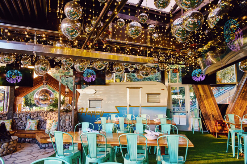 Dining room at Happy Camper Pizza in Las Vegas with camper in background
