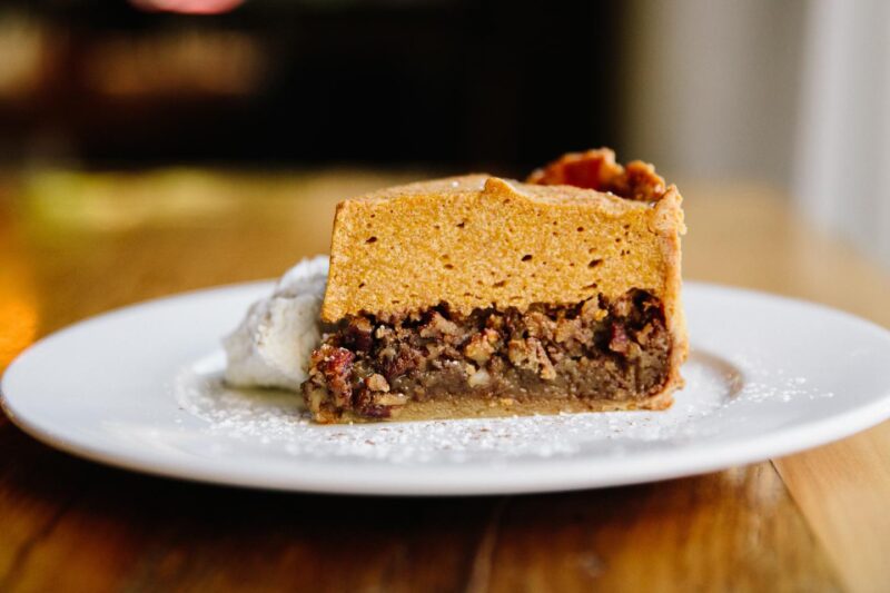 think slice on Beatrix's Pumpkin Pecan pie on a white plate