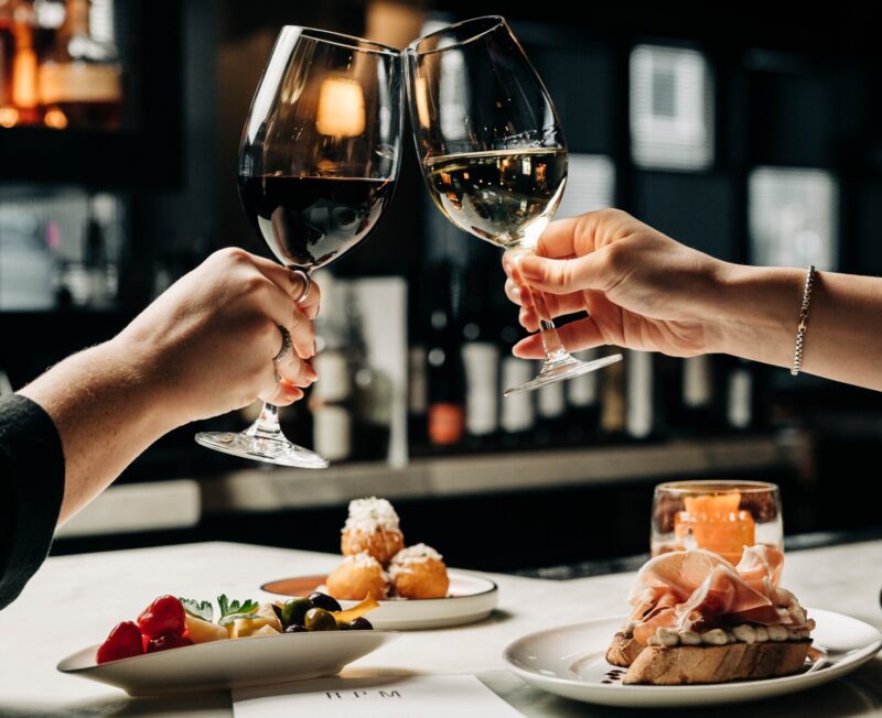 Two people enjoying wine and appetizers at RPM Italian