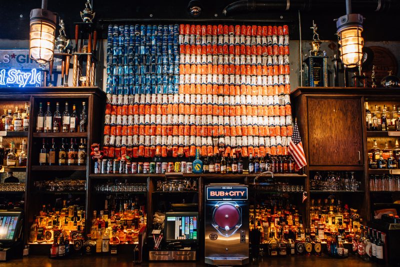 Wall of beer cans in the shape of the American Flag