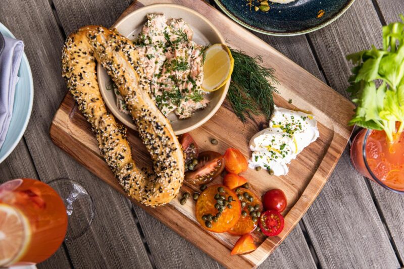 Platter of Jerusalem bagel with smoked salmon and cut fruits