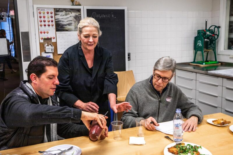 Chef Rita doing a tasting with partners in the kitchen