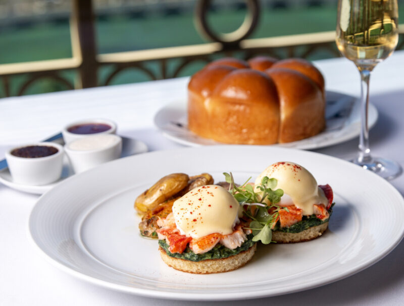 Eggs Benedict at Eiffel Tower Restaurant served with bread and a glass of champagne