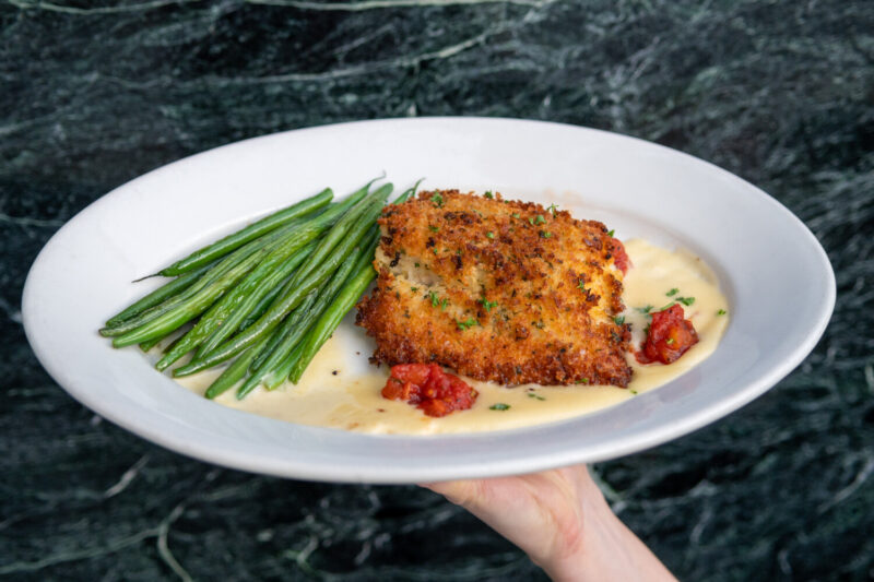 Wildfire's Parmesan Crusted Fresh Atlantic Cod served with roasted green beans, tomato jam and a light lemon butter sauce