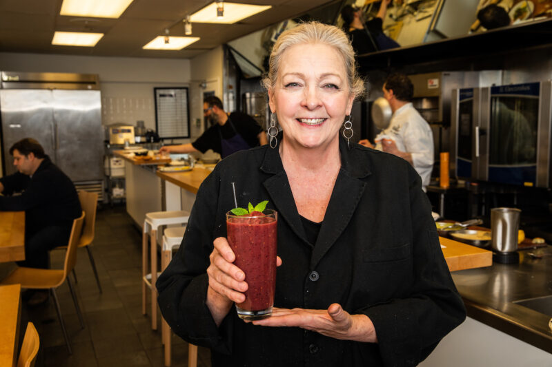 Chef Rita holding one of her smoothie creations in the LEYE test kitchen