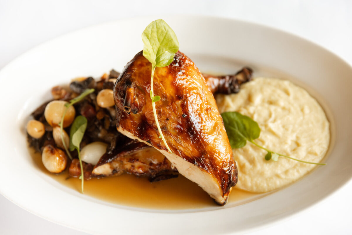 Mon Ami Gabi's Roast Chicken a la Grand-Mère with thick-cut bacon, sautéed mushrooms, pommel purée and chicken au jus