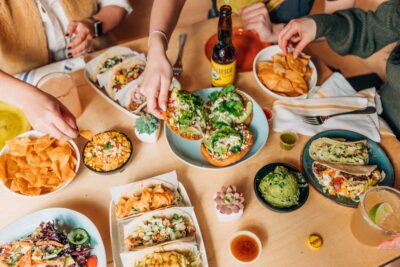 Overhead shot of popular dishes being shared on a table