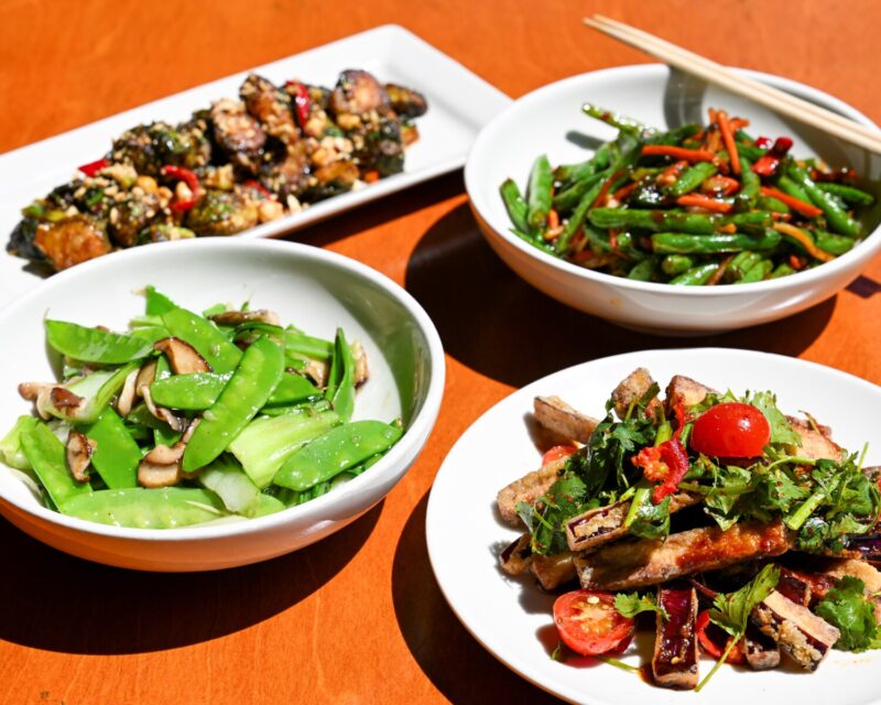 A spread of new shareable vegetable dishes on a table at Big Bowl.