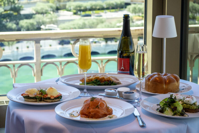 A spread of brunch dishes and a mimosa at Eiffel Tower Restaurant