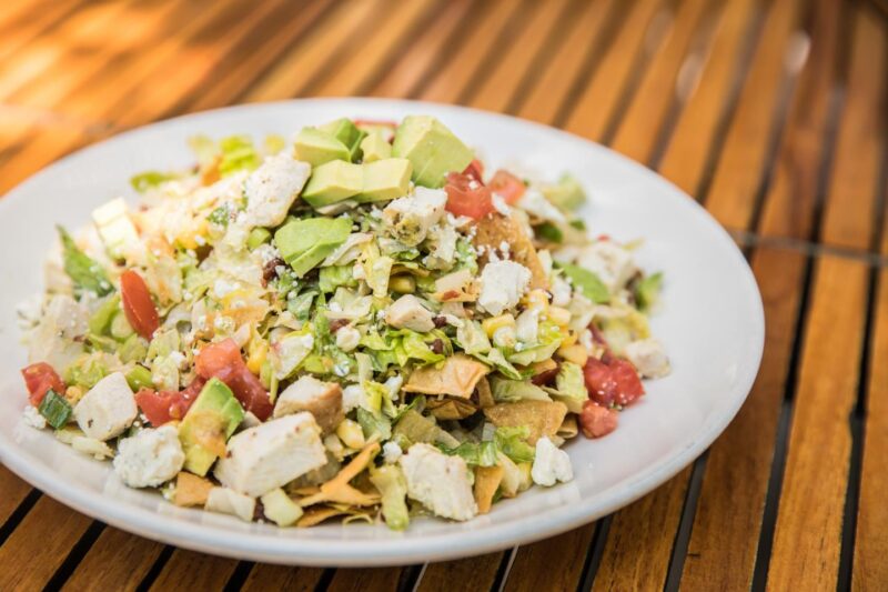 Plate of chopped salad from Wildfire with lettuce, tomatoes, avocado, and other finely chopped toppings