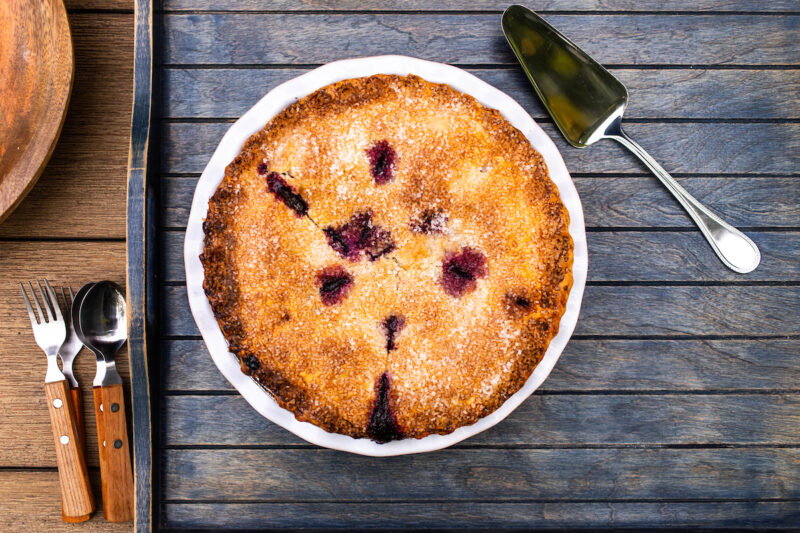 Wildfire's Blueberry Pie presented in a plate and resting on a wooden tray