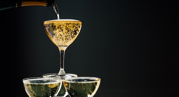 Champagne Tower with champagne being poured into the top glass