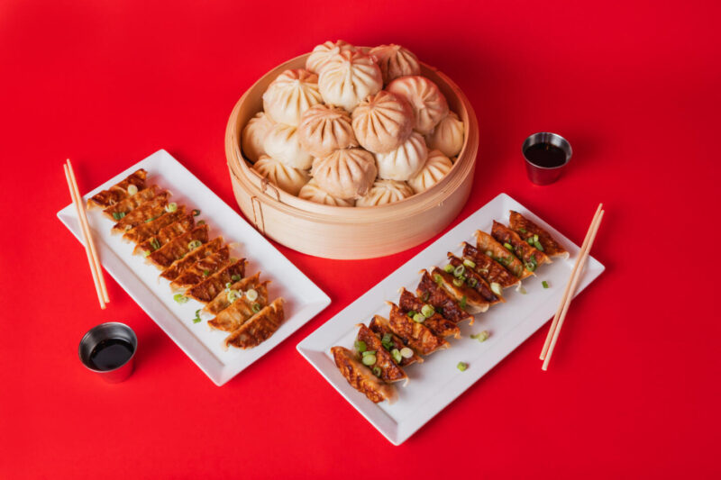 Wow Bao's potstickers and baos presented on a bright red background