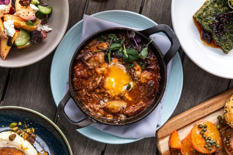 Short Rib Shakshouka on a table with other side dishes