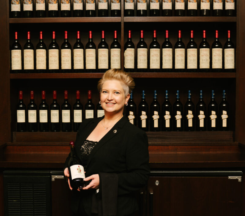 Sara Wurz Headshot from Joe's holding a bottle of wine